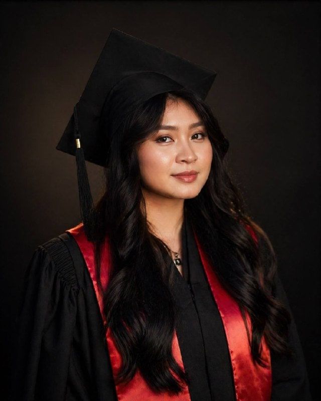 Kimleng in cap and gown at her Marie and Louis Pasteur University graduation